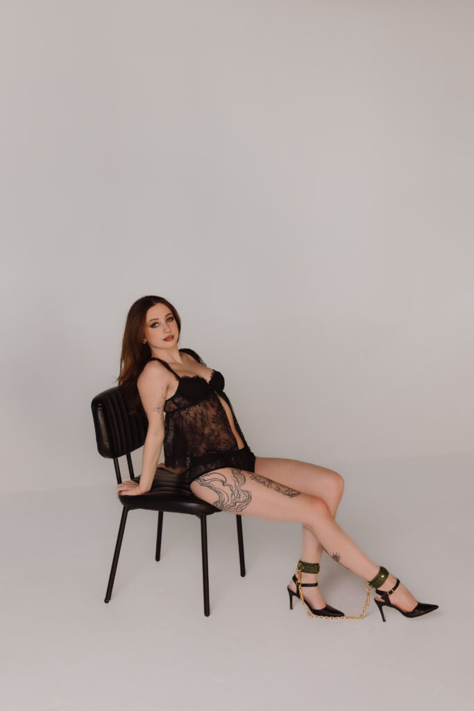 Boudoir photo by Oklahoma City photographer, Crystal Shaw, featuring green leather cuffs with gold connecting chain from Lovey Subby.